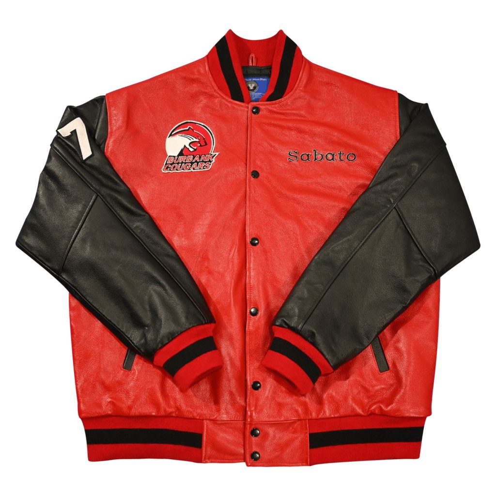 Red leather body letterman jacket featuring black leather sleeves, "BURBANK COUGARS" cougar mascot chest patch, custom "Sabato" embroidery, number "7" sleeve patch, and black-striped red ribbed trim from our letterman jackets online collection.
